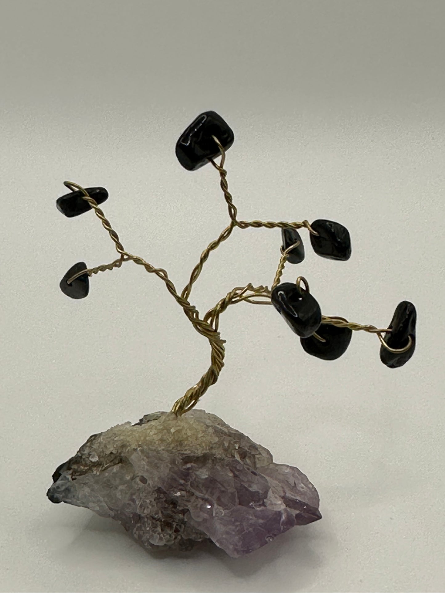 Obsidian chip tree on amethyst